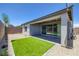 Enclosed backyard features artificial turf, rock landscaping, and covered patio at 9617 Sard Ln, Las Vegas, NV 89143