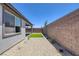 Backyard features artificial turf, neutral rock landscaping, and gray stucco wall at 9617 Sard Ln, Las Vegas, NV 89143
