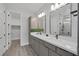 Elegant bathroom featuring a double sink vanity, sleek fixtures, and a glass-enclosed shower with a rain showerhead at 9617 Sard Ln, Las Vegas, NV 89143