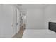 Minimalist bedroom with neutral tones, modern furnishings, and access to the closet, offering a serene living space at 9617 Sard Ln, Las Vegas, NV 89143