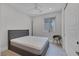 Clean bedroom with modern decor, a grey upholstered bed, a ceiling fan, and a window letting in natural light at 9617 Sard Ln, Las Vegas, NV 89143