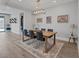 Elegant dining room with a wood table, black chairs, and modern lighting at 9617 Sard Ln, Las Vegas, NV 89143