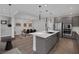 Modern kitchen with grey cabinetry, stainless steel appliances, and a white countertop island at 9617 Sard Ln, Las Vegas, NV 89143