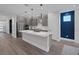 Bright, modern kitchen featuring a large island, gray cabinets, and stainless steel appliances at 9617 Sard Ln, Las Vegas, NV 89143