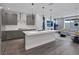 Modern kitchen with stainless steel appliances, a large island, and a view into the living room at 9617 Sard Ln, Las Vegas, NV 89143