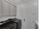 Efficient laundry room featuring modern washer and dryer and ample cabinet space at 9617 Sard Ln, Las Vegas, NV 89143