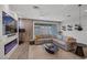 Spacious living room featuring modern fireplace, neutral decor, and sliding glass door at 9617 Sard Ln, Las Vegas, NV 89143
