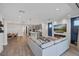 Open concept living room and kitchen with stainless appliances and modern furnishings at 9617 Sard Ln, Las Vegas, NV 89143