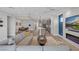 Open-concept living space featuring modern furnishings, dining area, and a stylish kitchen with stainless steel appliances at 9617 Sard Ln, Las Vegas, NV 89143