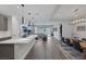 Open-concept living space showcasing modern kitchen, dining, and living areas with ample lighting at 9617 Sard Ln, Las Vegas, NV 89143