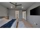 Spacious bedroom with grey walls, modern lighting, and views of the walk-in closet and bathroom at 9617 Sard Ln, Las Vegas, NV 89143