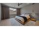 Sleek bedroom with a platform bed, decorative wall paneling, and a large window offering natural light at 9617 Sard Ln, Las Vegas, NV 89143