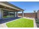 A covered patio features artificial grass and sliding glass doors for seamless indoor/outdoor living at 9617 Sard Ln, Las Vegas, NV 89143