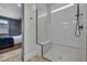 Modern walk-in shower features white subway tiles, bench seating, and a sleek glass enclosure, with a view to the bedroom at 9617 Sard Ln, Las Vegas, NV 89143