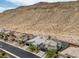 Aerial view of the home in a desert community with mountain views, lush landscaping, and nearby homes at 9789 Twilight Moon Ave, Las Vegas, NV 89148