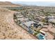 Aerial view of a desert community showcasing lush landscaping, mountain views, and neighborhood layout at 9789 Twilight Moon Ave, Las Vegas, NV 89148