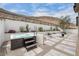 Relaxing backyard featuring a modern hot tub, desert landscaping, and mountain views at 9789 Twilight Moon Ave, Las Vegas, NV 89148