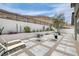 This desert landscape backyard includes a patio, pavers, gravel, drought resistant landscaping, and mountain views at 9789 Twilight Moon Ave, Las Vegas, NV 89148