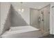 Elegant bathroom features free standing shower and garden tub with custom tile at 9789 Twilight Moon Ave, Las Vegas, NV 89148