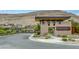 Terra Luna community entrance featuring stone architecture, a gate, and mature landscaping at 9789 Twilight Moon Ave, Las Vegas, NV 89148