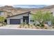 Modern home with a flat roof, two-car garage, desert landscaping, and mountain views at 9789 Twilight Moon Ave, Las Vegas, NV 89148