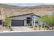 Modern home with a flat roof, two-car garage, desert landscaping, and mountain views at 9789 Twilight Moon Ave, Las Vegas, NV 89148