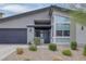 Modern home with a flat roof, two-car garage, and desert landscaping at 9789 Twilight Moon Ave, Las Vegas, NV 89148