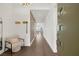 Bright foyer with wood floors, modern lighting, chair and views of living room at 9789 Twilight Moon Ave, Las Vegas, NV 89148