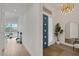 Inviting foyer with a modern door, stylish mirror, and a view of the living room beyond at 9789 Twilight Moon Ave, Las Vegas, NV 89148