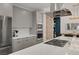 Contemporary kitchen featuring gray cabinets, stainless steel appliances, and a large island with built-in stovetop at 9789 Twilight Moon Ave, Las Vegas, NV 89148
