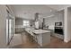 Bright kitchen features gray cabinets, stainless appliances, a large island with seating, and access to the backyard at 9789 Twilight Moon Ave, Las Vegas, NV 89148