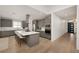 Modern kitchen featuring gray cabinets, stainless steel appliances, large island, and light hardwood flooring at 9789 Twilight Moon Ave, Las Vegas, NV 89148