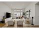 Bright living room boasts stylish furnishings, a large TV, and expansive windows offering picturesque outdoor views at 9789 Twilight Moon Ave, Las Vegas, NV 89148