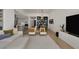 Bright, open-concept living room featuring modern decor, stylish furnishings, and seamless flow into the kitchen and dining area at 9789 Twilight Moon Ave, Las Vegas, NV 89148