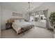 Light and airy bedroom with view of private patio and a modern hanging light at 9789 Twilight Moon Ave, Las Vegas, NV 89148