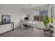 Bright home office with a modern desk setup, comfortable chair, and a view of the outdoors at 9789 Twilight Moon Ave, Las Vegas, NV 89148