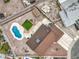 A bird's eye view of a home with a backyard pool, lush landscaping, and the surrounding neighborhood at 1004 Woodside Ct, Henderson, NV 89015