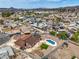 This aerial shot showcases a home with a beautiful backyard, inviting pool, and close proximity to the community at 1004 Woodside Ct, Henderson, NV 89015