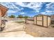 Backyard showcases a pool, green lawn, shed and a patio, perfect for outdoor relaxation and enjoyment at 1004 Woodside Ct, Henderson, NV 89015