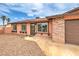 This single story home has three large picture windows and a 2-car garage at 1004 Woodside Ct, Henderson, NV 89015