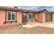 Inviting front entrance with a secure screen door, mature landscaping, and covered porch at 1004 Woodside Ct, Henderson, NV 89015