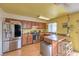 Functional kitchen with stainless steel appliances, wood cabinets, and eat-in breakfast area at 1004 Woodside Ct, Henderson, NV 89015