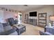 Comfortable living room with plenty of seating space, fireplace, and entertainment center at 1004 Woodside Ct, Henderson, NV 89015
