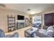Bright living room featuring modern decor, entertainment center, and natural light at 1004 Woodside Ct, Henderson, NV 89015