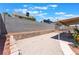 Backyard showcasing gravel landscaping, block wall, and partial covered patio at 1012 Greystone Dr, Las Vegas, NV 89108