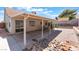 Backyard featuring covered patio, rocks, and gravel at 1012 Greystone Dr, Las Vegas, NV 89108