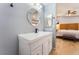 Bathroom vanity features modern gold framed mirror, white counter and cabinets, and black fixtures at 1012 Greystone Dr, Las Vegas, NV 89108