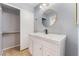 Bathroom featuring vanity with modern sink and fixtures, closet, and large mirror at 1012 Greystone Dr, Las Vegas, NV 89108