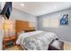 Bedroom features a padded headboard, TV, side table with lamp, and patterned bedding at 1012 Greystone Dr, Las Vegas, NV 89108