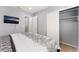 Bedroom featuring wall-mounted TV, lamps, and a large closet at 1012 Greystone Dr, Las Vegas, NV 89108